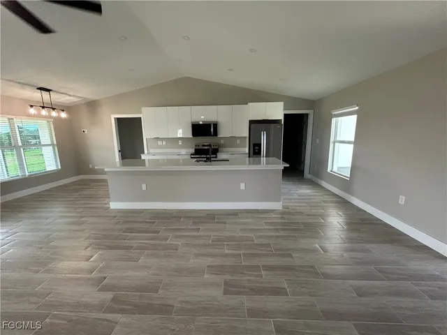 a view of a kitchen with a sink and a stove top oven