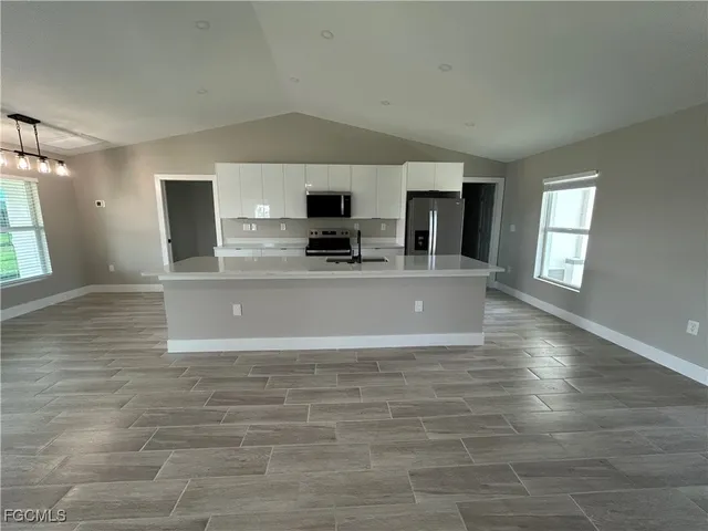 a view of a kitchen with microwave and cabinets