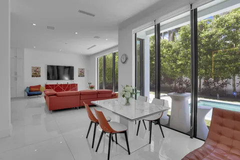 a view of a patio with a table chairs and a swimming pool