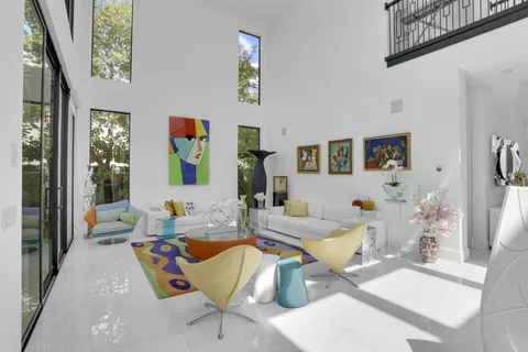 a view of an house with swimming pool and porch with furniture