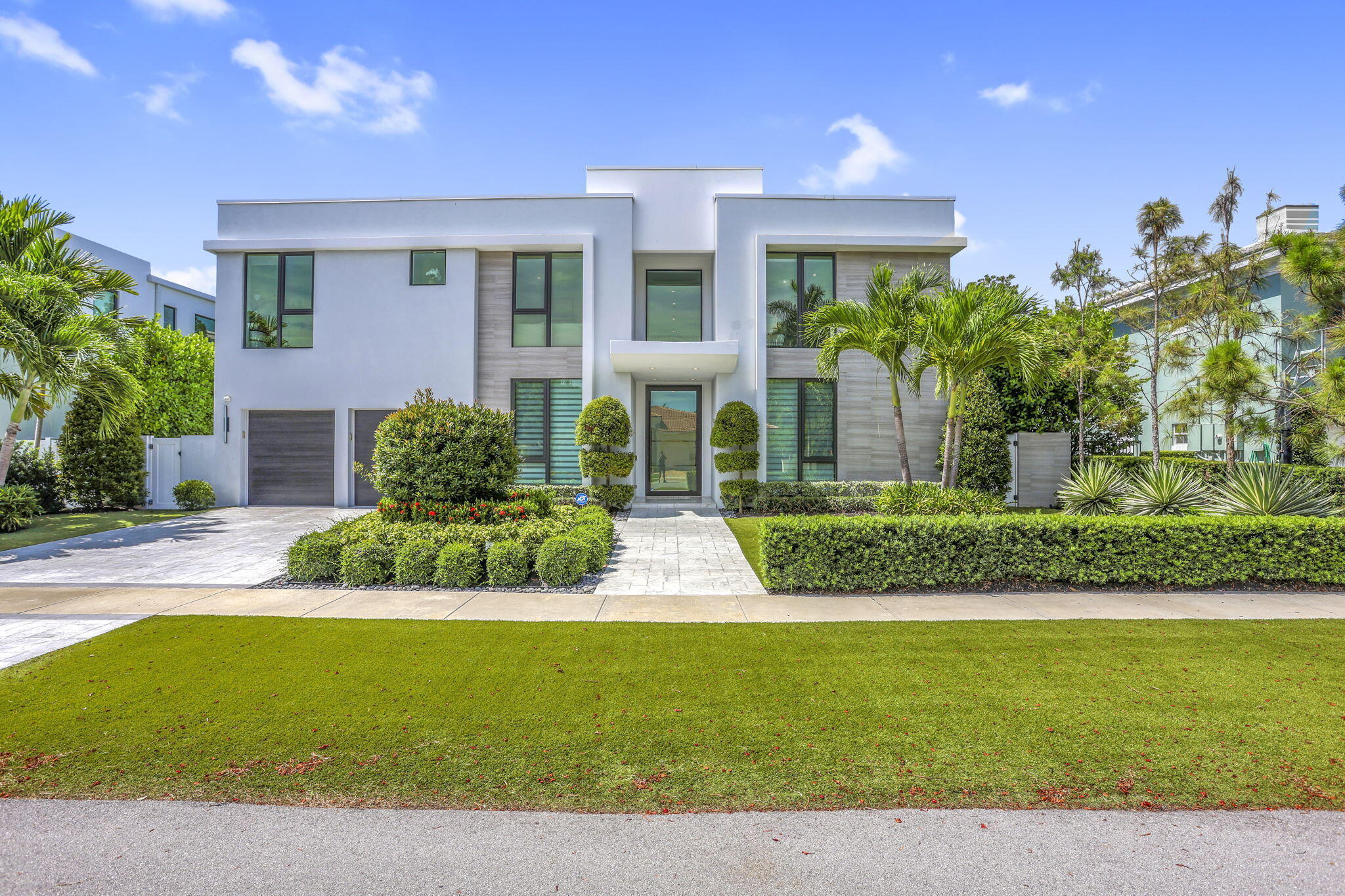234 Northeast 4th Street Boca Raton, FL 33432 - Photo 3 of 72 a front view of a house with a yard and potted plants