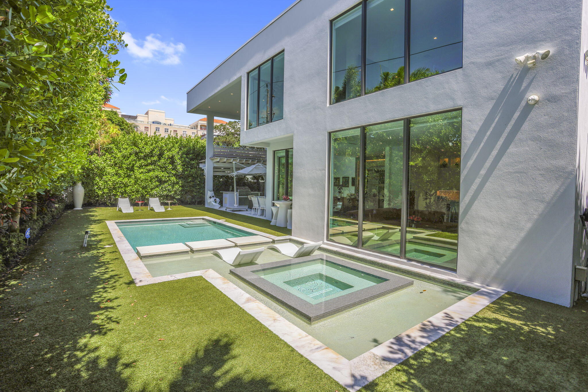 234 Northeast 4th Street Boca Raton, FL 33432 - Photo 33 of 72 a view of an house with swimming pool and porch with furniture