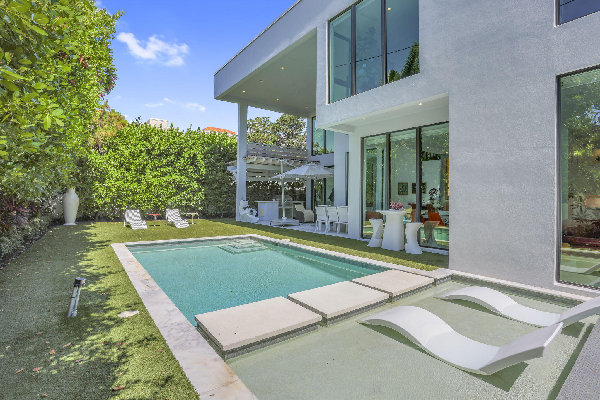 234 Northeast 4th Street Boca Raton, FL 33432 - Photo 34 of 72 a view of a patio with a table and chairs under an umbrella