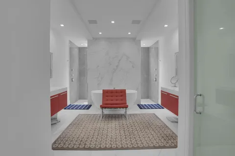 a front view of a house with garden and trees