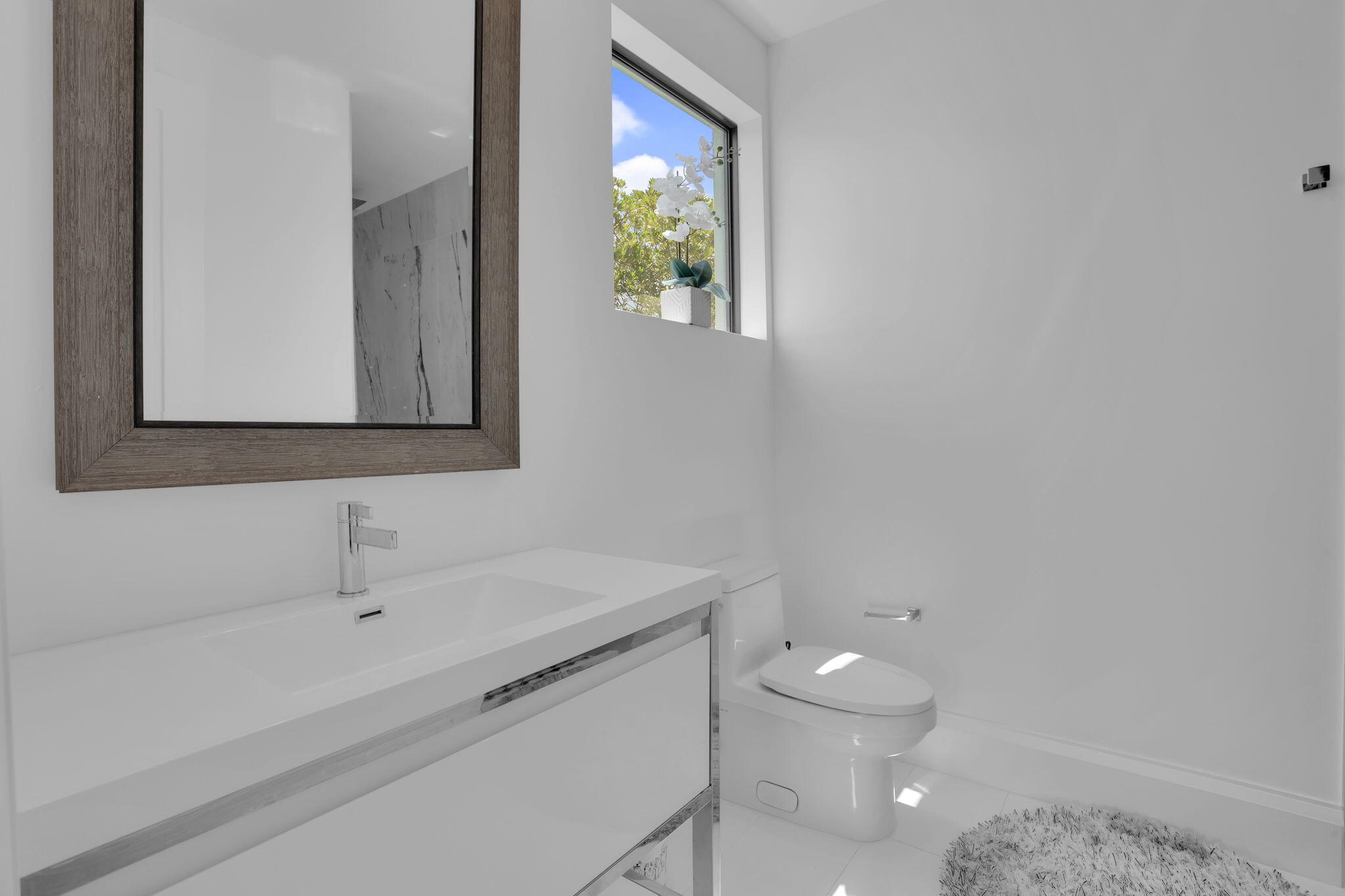 234 Northeast 4th Street Boca Raton, FL 33432 - Photo 59 of 72 a bathroom with a sink and a mirror