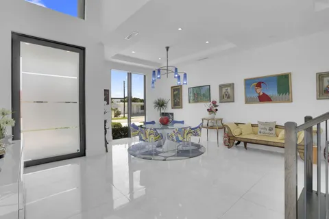 a kitchen with kitchen island granite countertop a white table and chairs in it