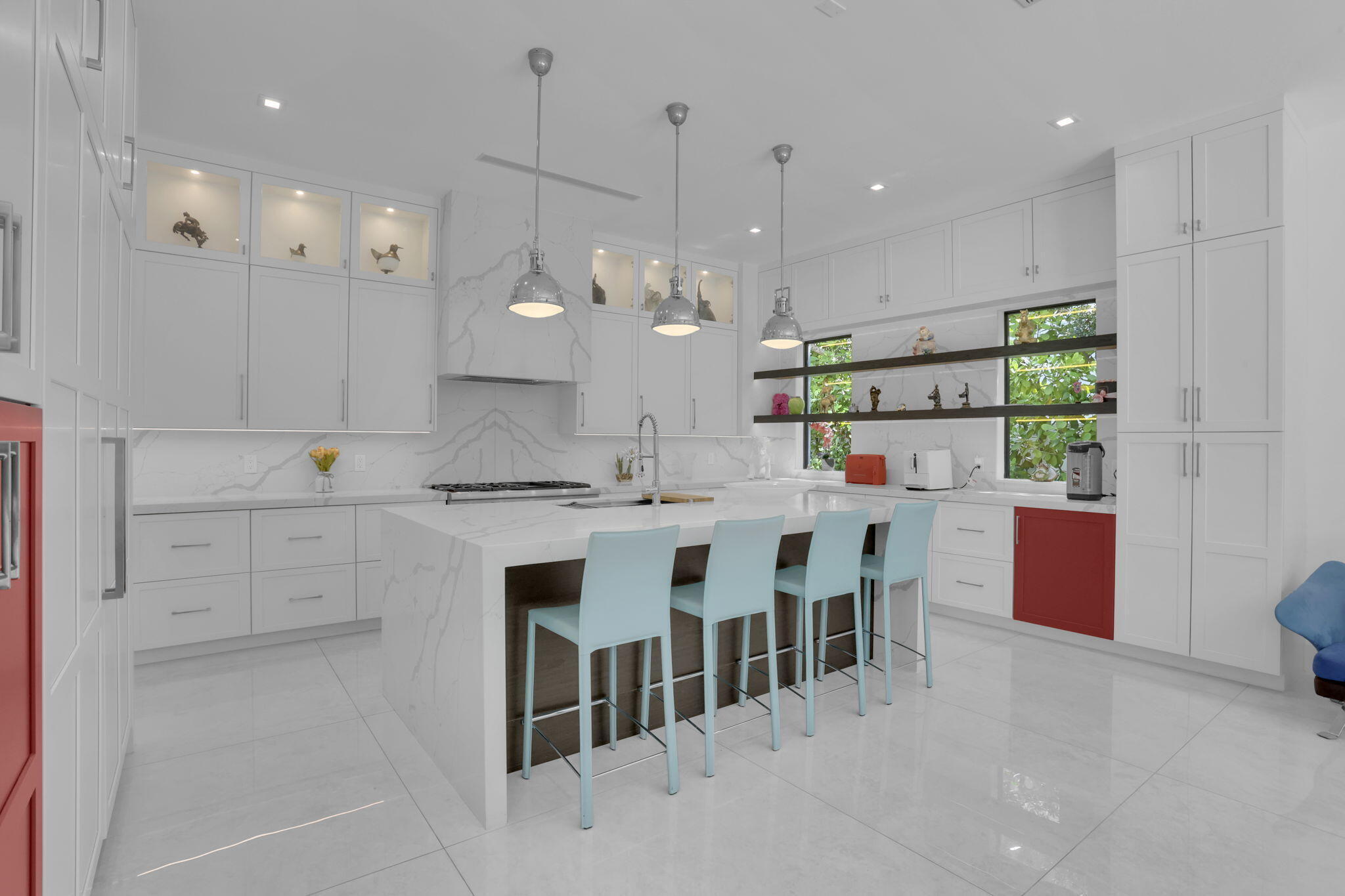 234 Northeast 4th Street Boca Raton, FL 33432 - Photo 8 of 72 a kitchen with kitchen island granite countertop a white table and chairs in it