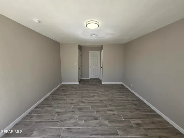 a view of an empty room and wooden floor