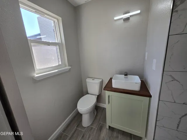 a white toilet sitting next to a window