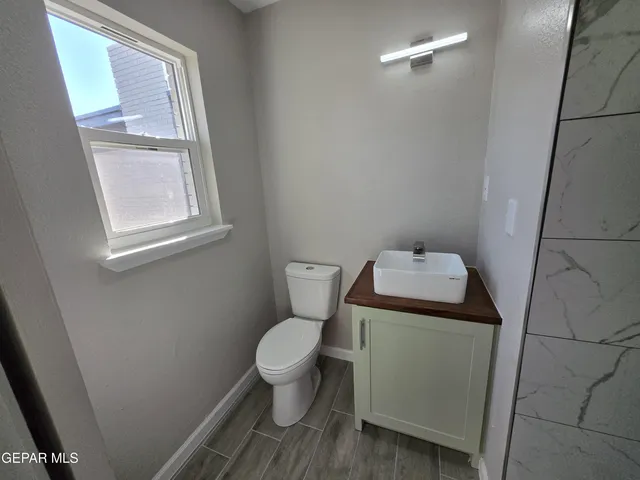 a bathroom with a toilet and a mirror