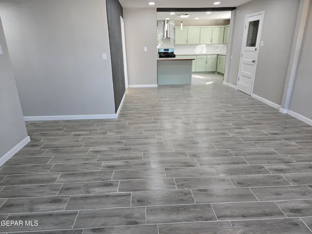 a view of a kitchen with cabinets and wooden floor