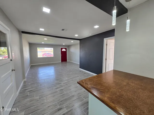 a view of wooden floor and windows in a room