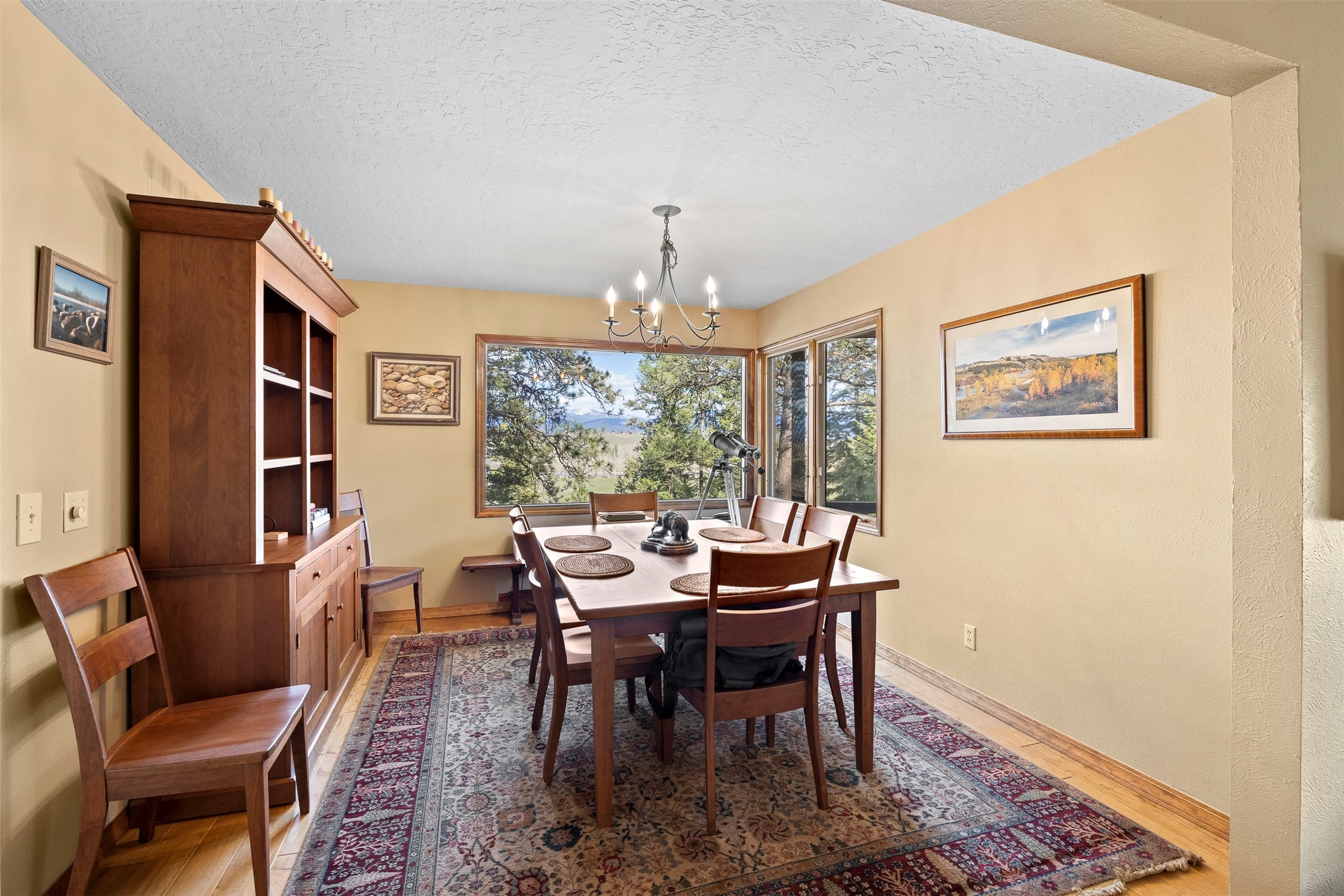 730 Big Flat Road Missoula, MT 59804 - Photo 27 of 59 Dining area with hanging lights, a textured ceiling, and light wood finished floors