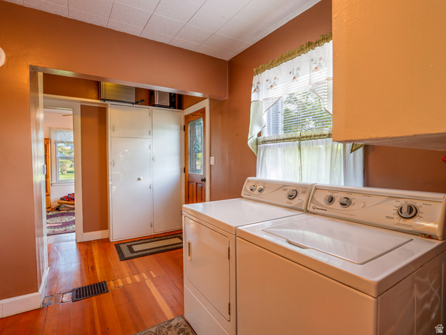155 West Center Street Fillmore, UT 84631 - Photo 34 of 86 Laundry area featuring a window with blinds, a built-in cabinet for storage, and warm-toned wood flooring