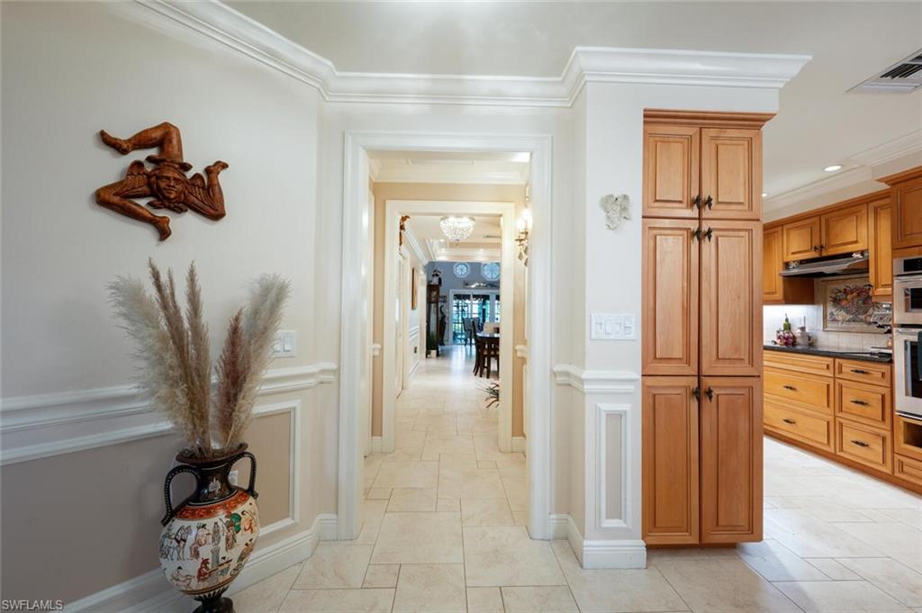644 Augusta Boulevard Naples, FL 34113 - Photo 11 of 40 a view of a hallway and a livingroom with furniture