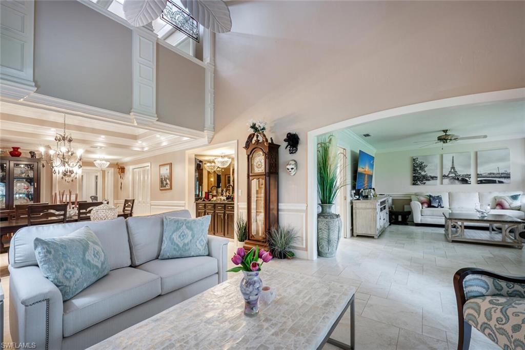 644 Augusta Boulevard Naples, FL 34113 - Photo 14 of 40 a living room with furniture and a chandelier