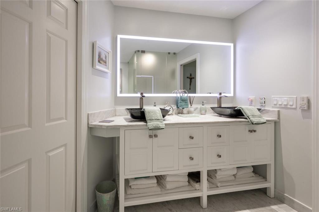 644 Augusta Boulevard Naples, FL 34113 - Photo 19 of 40 a bathroom with a sink and a mirror