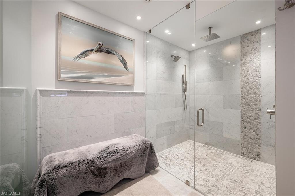 644 Augusta Boulevard Naples, FL 34113 - Photo 20 of 40 a bedroom with a bed and a mirror