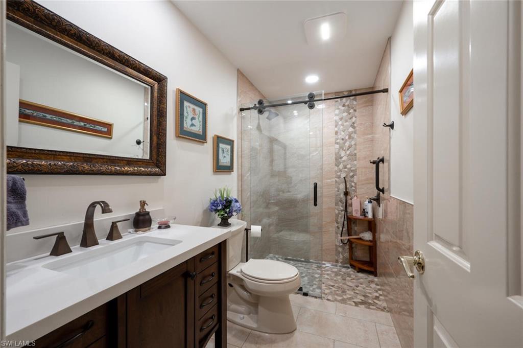 644 Augusta Boulevard Naples, FL 34113 - Photo 22 of 40 a bathroom with a sink a toilet and shower