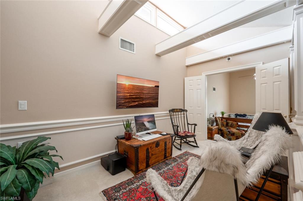 644 Augusta Boulevard Naples, FL 34113 - Photo 24 of 40 a living room with furniture and a flat screen tv