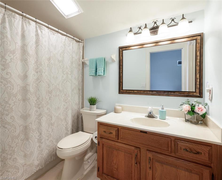 644 Augusta Boulevard Naples, FL 34113 - Photo 25 of 40 a bathroom with a toilet a sink and a mirror