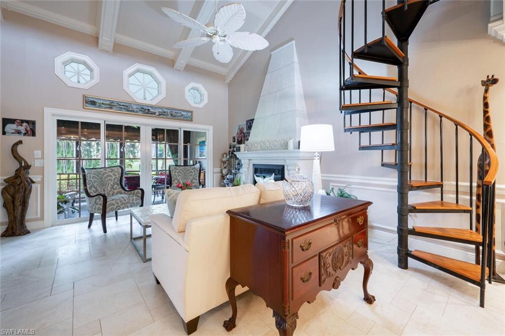 644 Augusta Boulevard Naples, FL 34113 - Photo 3 of 40 a living room with furniture a clock and a large window