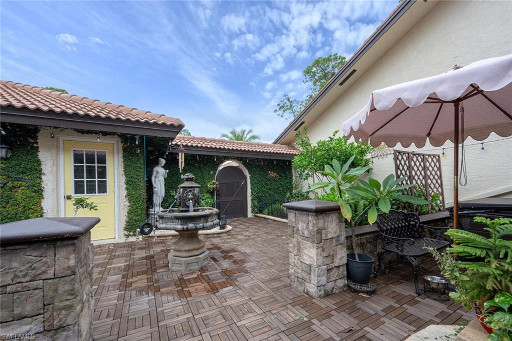 644 Augusta Boulevard Naples, FL 34113 - Photo 33 of 40 a view of a chair and table in patio with a fire pit