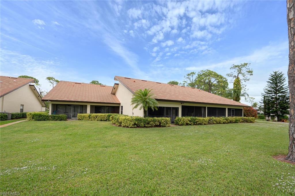 644 Augusta Boulevard Naples, FL 34113 - Photo 36 of 40 a front view of a house with a garden