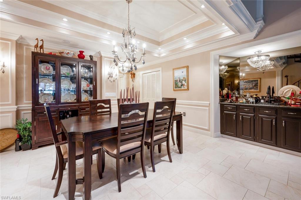 644 Augusta Boulevard Naples, FL 34113 - Photo 4 of 40 a view of a dining room with furniture and chandelier