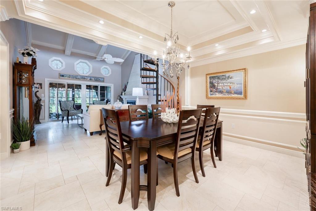 644 Augusta Boulevard Naples, FL 34113 - Photo 5 of 40 a view of a dining room with furniture a chandelier and wooden floor