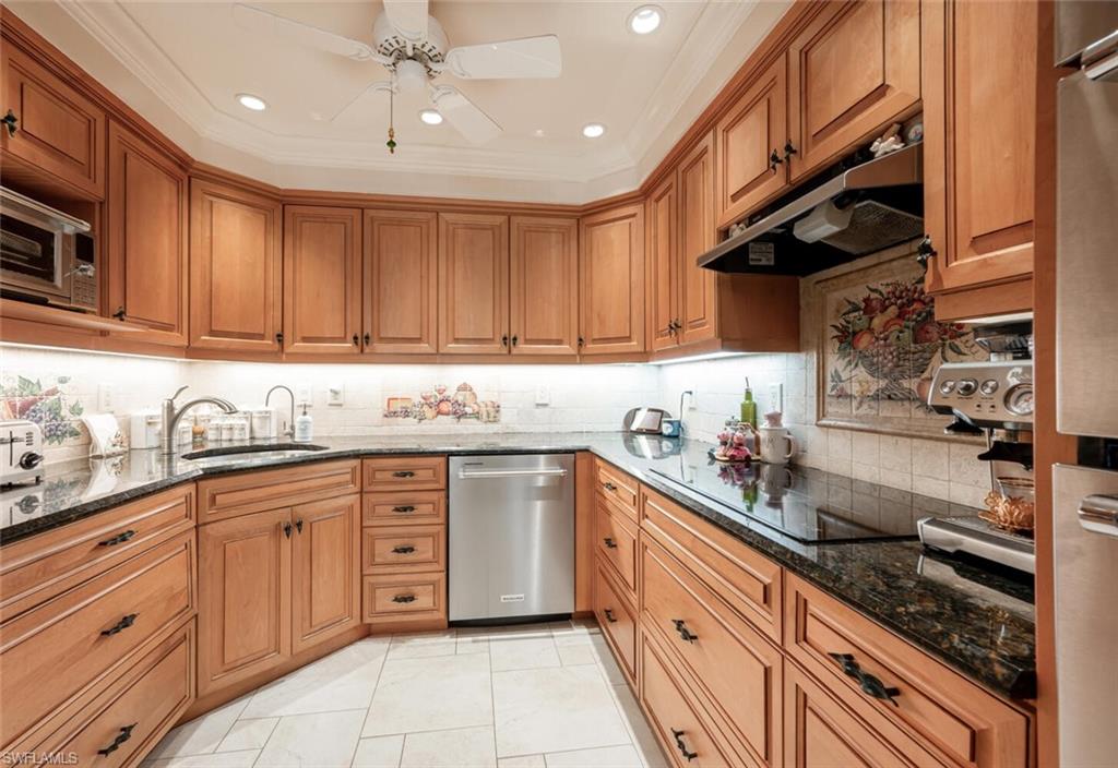 644 Augusta Boulevard Naples, FL 34113 - Photo 6 of 40 a kitchen with granite countertop a sink stainless steel appliances and cabinets