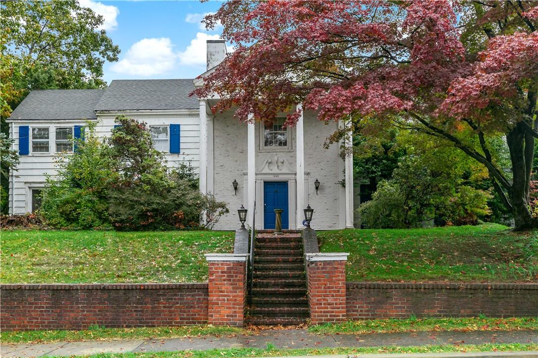 a front view of a house with a garden and yard