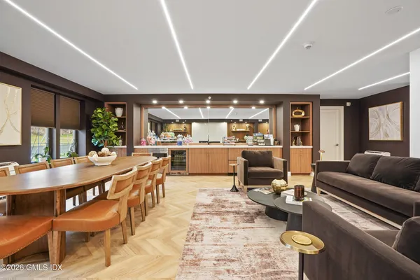 a view of a kitchen with white cabinets and wooden floor