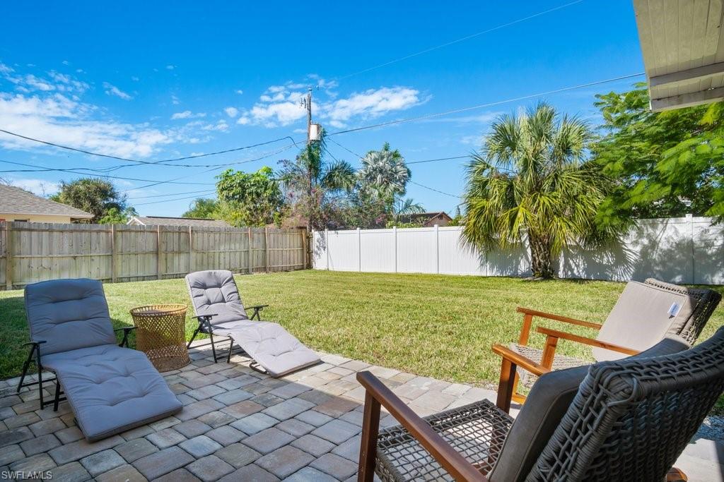 1207 Hernando Street Naples, FL 34103 - Photo 28 of 37 a view of a chairs and table in the back yard of the house