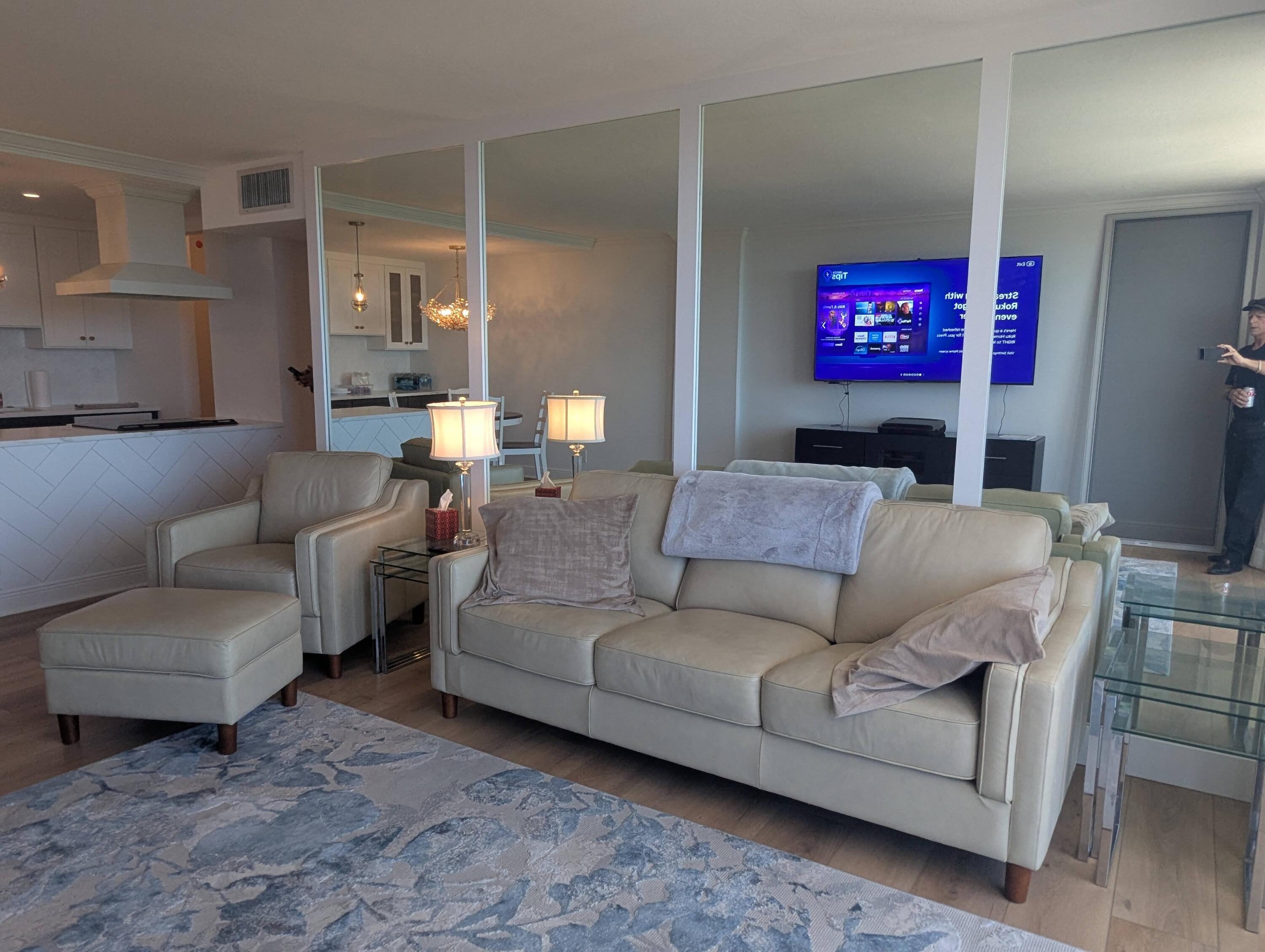 2121 North Ocean Boulevard, Unit 1006E Boca Raton, FL 33431 - Photo 34 of 64 a living room with furniture a fireplace and a flat screen tv