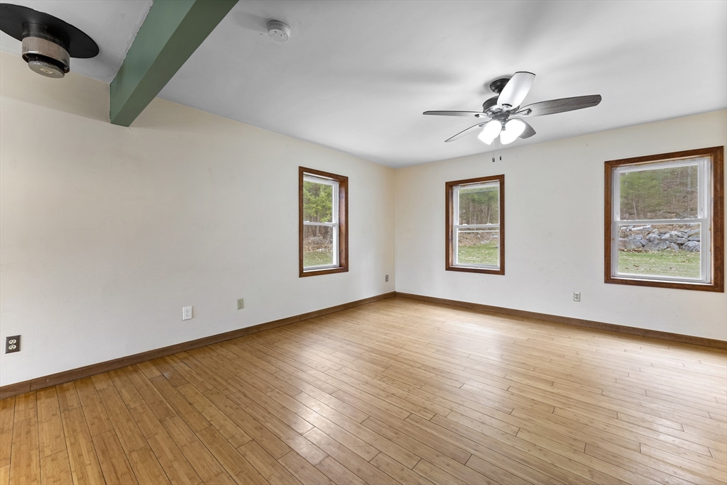147 Worthington Road Huntington, MA 01050 - Photo 12 of 39 a view of an empty room with a window and wooden floor
