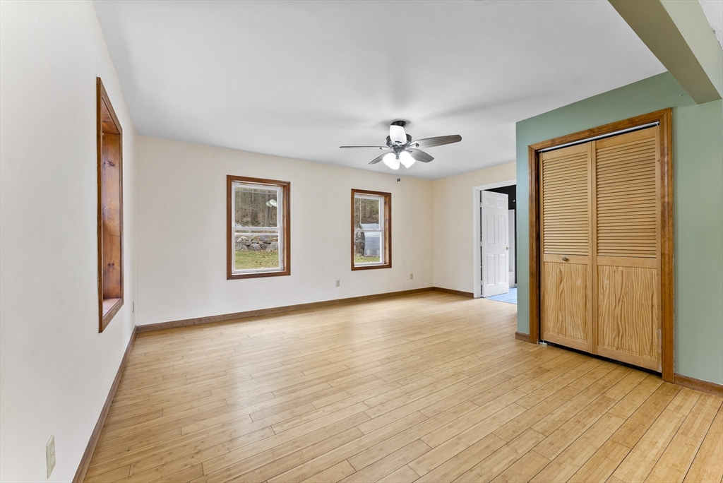147 Worthington Road Huntington, MA 01050 - Photo 13 of 39 a view of an empty room with window and wooden floor