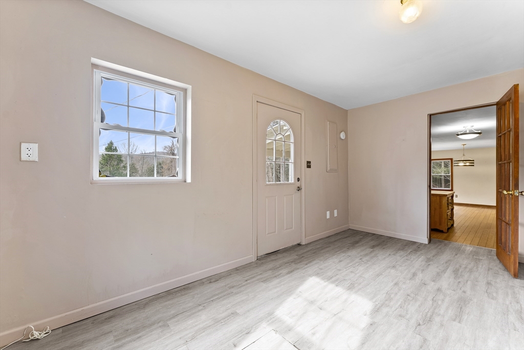 147 Worthington Road Huntington, MA 01050 - Photo 15 of 39 a view of an empty room with wooden floor and a window