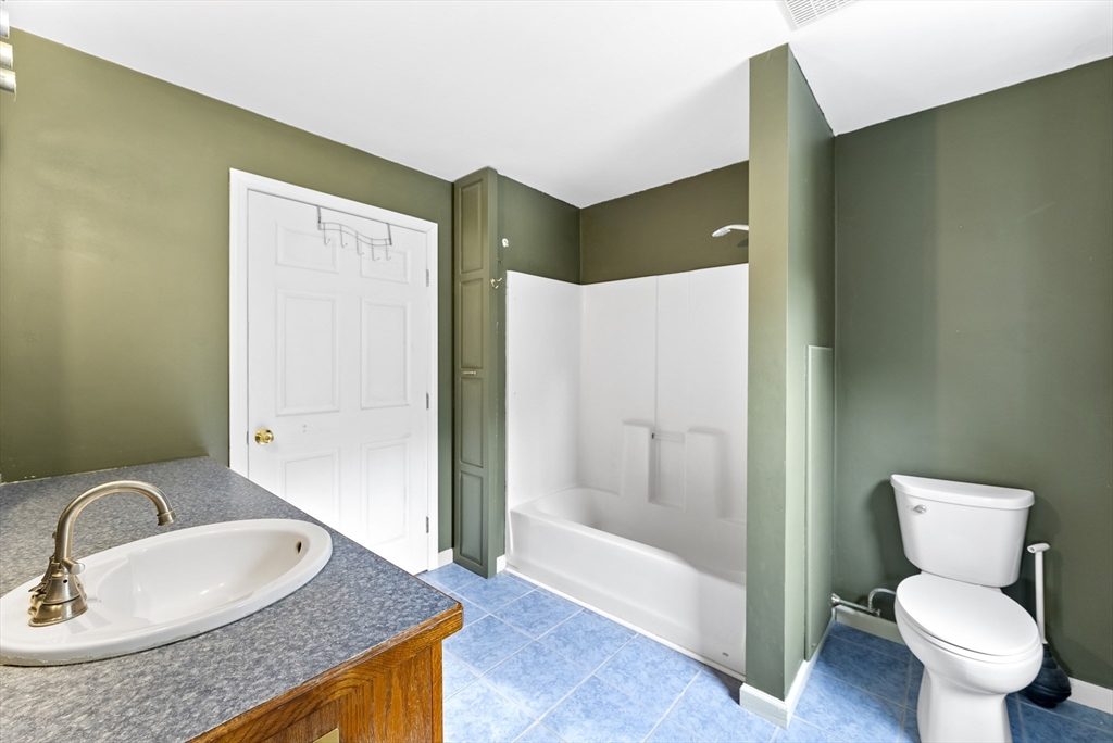 147 Worthington Road Huntington, MA 01050 - Photo 21 of 39 a bathroom with a granite countertop sink and a mirror