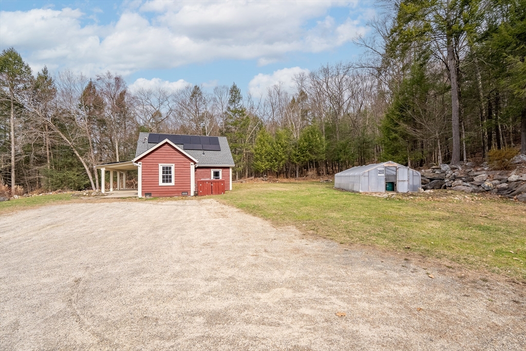 147 Worthington Road Huntington, MA 01050 - Photo 32 of 39 a front view of a house with a yard and garage