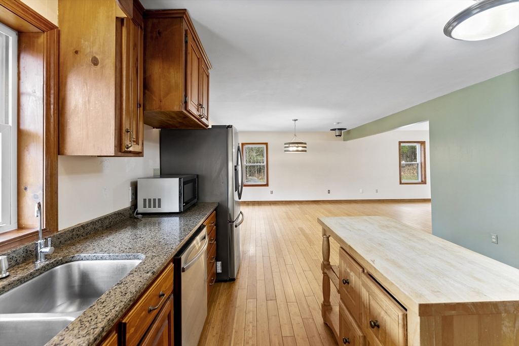 147 Worthington Road Huntington, MA 01050 - Photo 6 of 39 a kitchen with granite countertop a sink a stove and cabinets