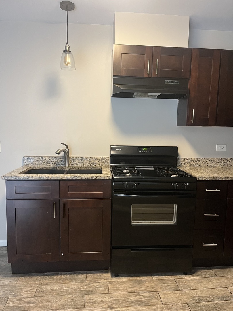 7501 SW Highway, Unit 5 Worth, IL 60482 - Photo 3 of 7 a kitchen with a cabinets and a stove