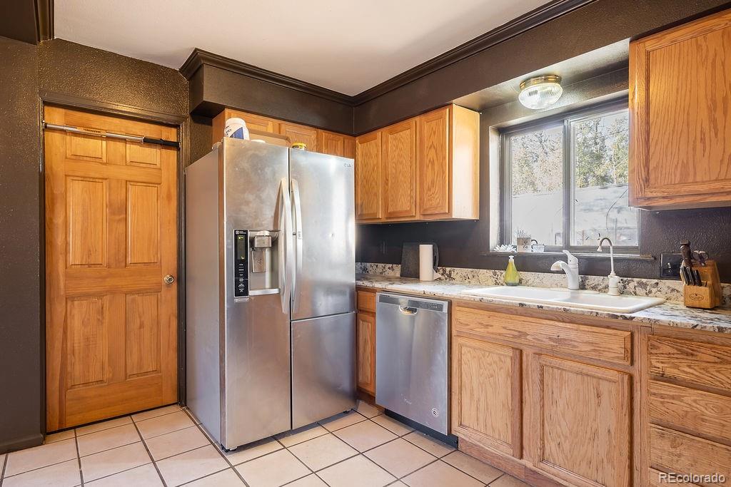 154 Cowan Road Bailey, CO 80421 - Photo 13 of 30 a kitchen with stainless steel appliances granite countertop a refrigerator and a sink