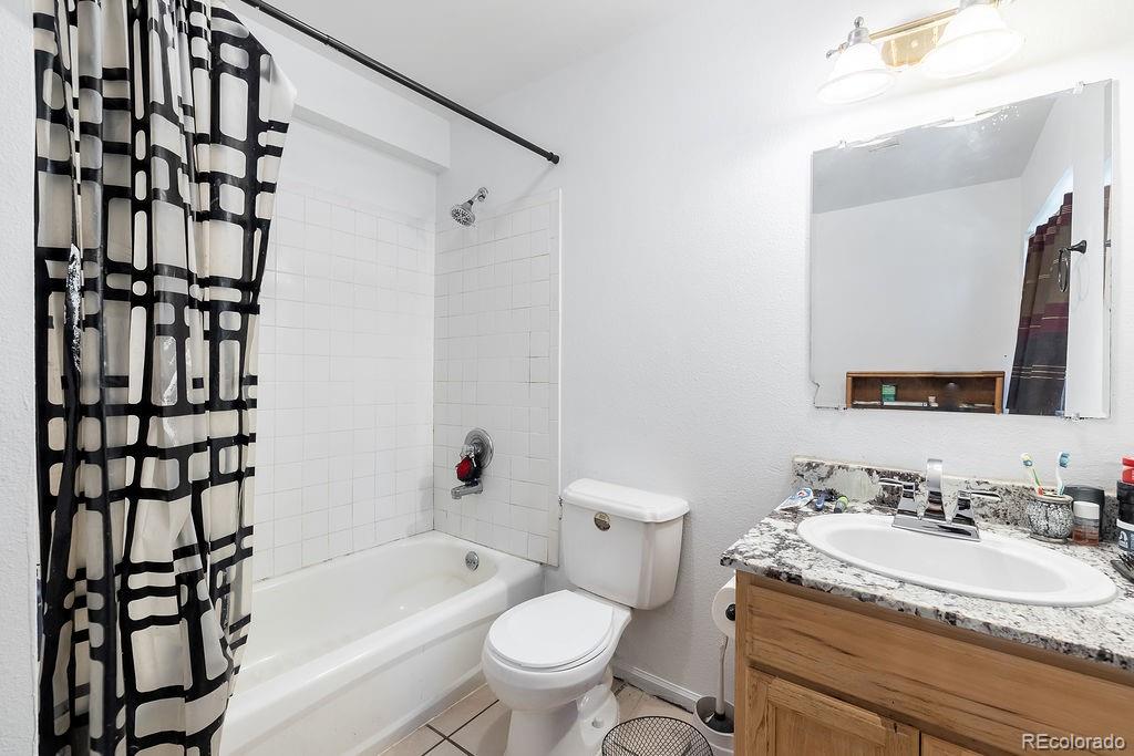 154 Cowan Road Bailey, CO 80421 - Photo 20 of 30 a bathroom with a granite countertop sink toilet mirror and shower