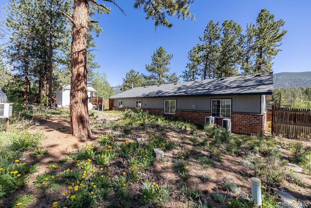 154 Cowan Road Bailey, CO 80421 - Photo 24 of 30 a front view of a house with garden