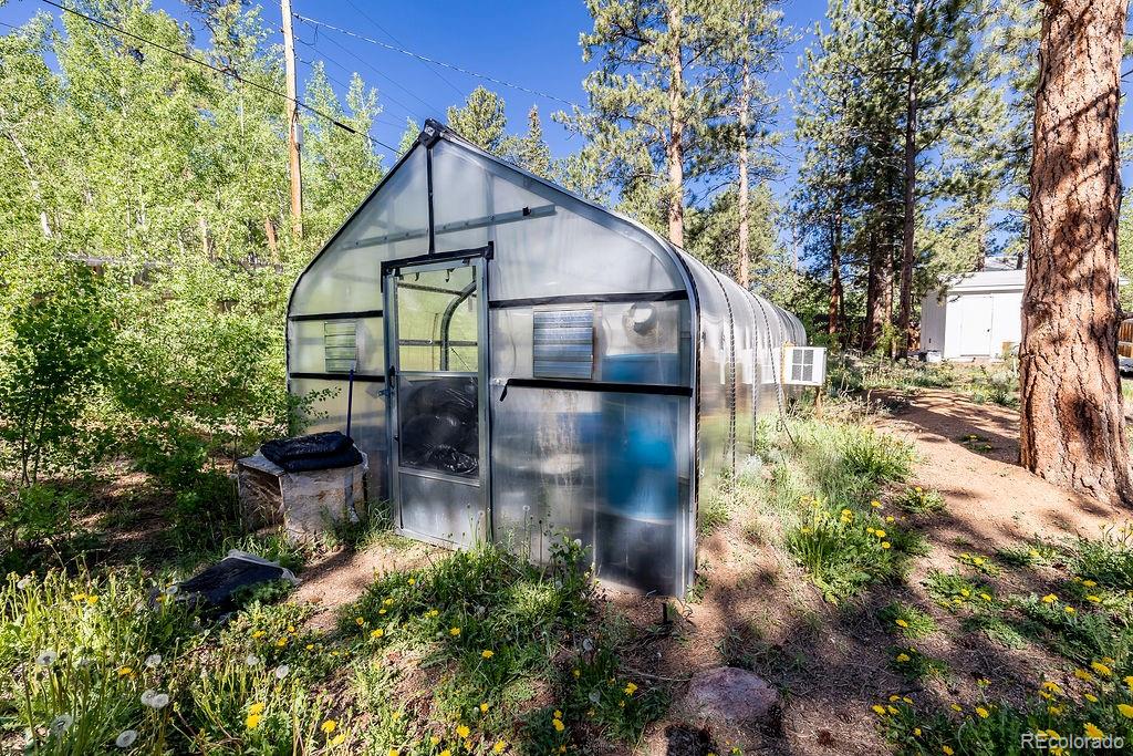 154 Cowan Road Bailey, CO 80421 - Photo 25 of 30 a backyard of a house with outdoor seating and plants