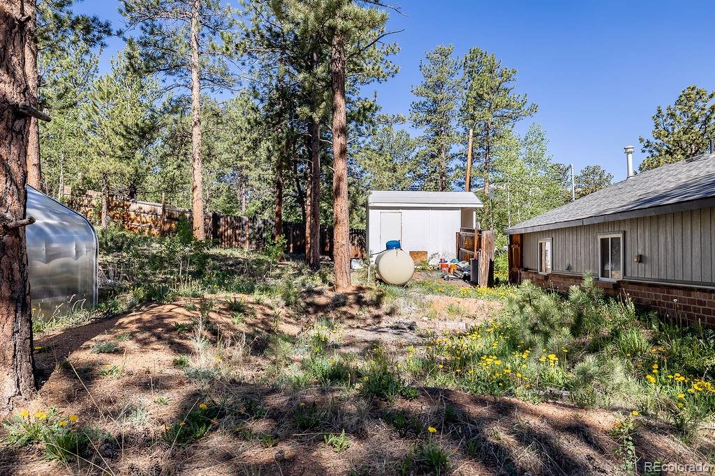 154 Cowan Road Bailey, CO 80421 - Photo 26 of 30 a view of a house with a yard and sitting area