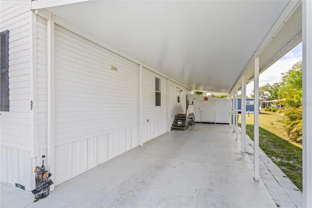 a view of a house with a yard and fence