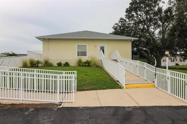 a view of a house with backyard and a patio