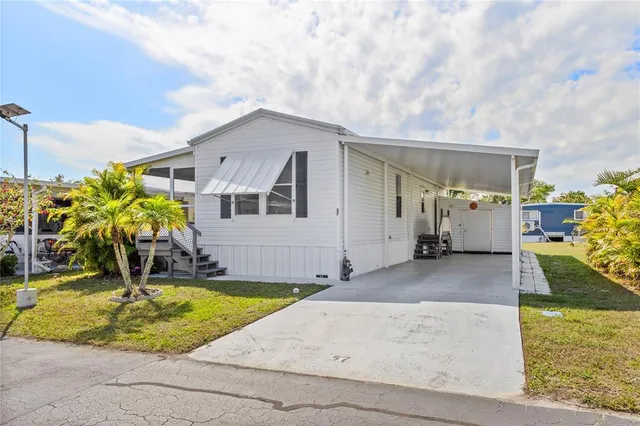a view of a house with a backyard